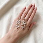 Crystal Blossom Chandelier Earrings on a hand for size reference