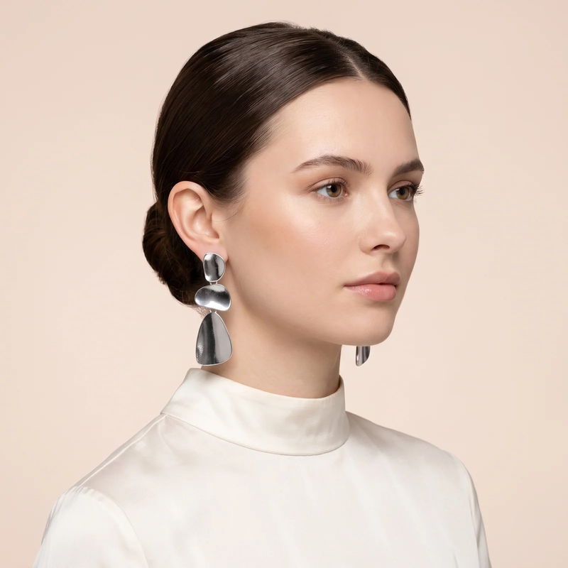 Model wearing silver Organic Pebble Tier Drop Earrings