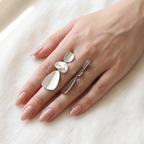 Organic Pebble Tier Drop Earrings on a hand for size reference