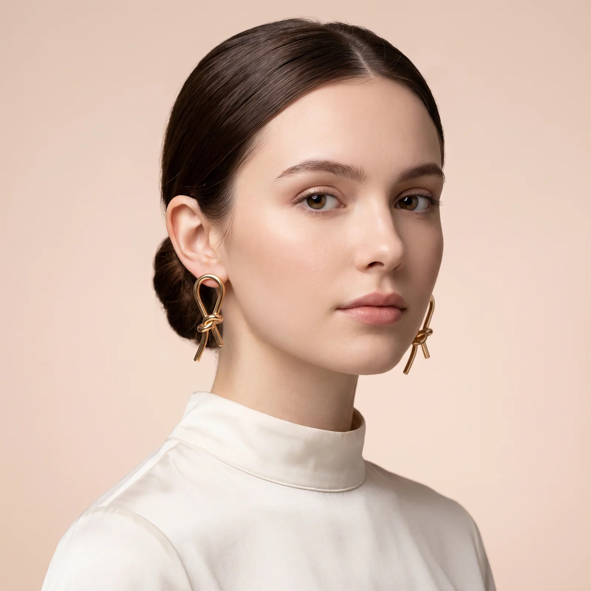 Model wearing Gold Knot Drop Earrings