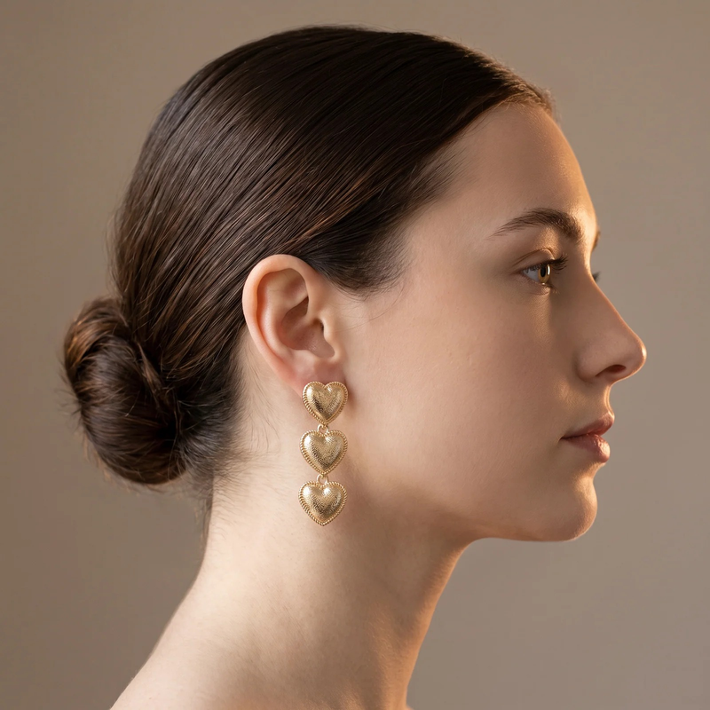 Side profile on ear: Triple Heart Drop Earrings
