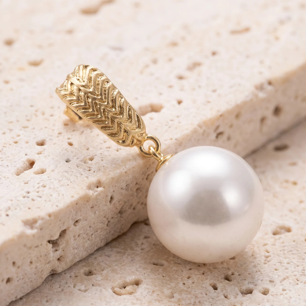 Close-up detail of Gold Textured Drop Pearl Earrings