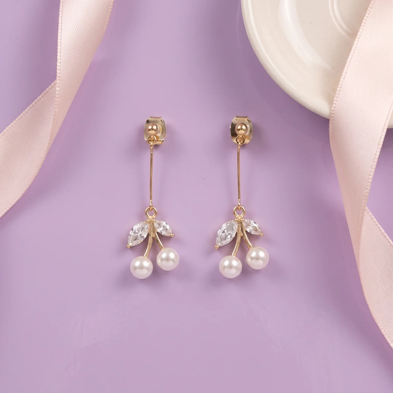 Flat lay of Pearl Cherry Drop Earrings