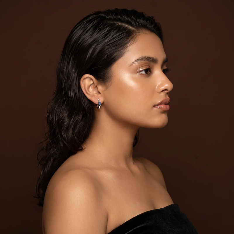 Side profile on ear: Gold Sapphire Baguette Huggie Earrings