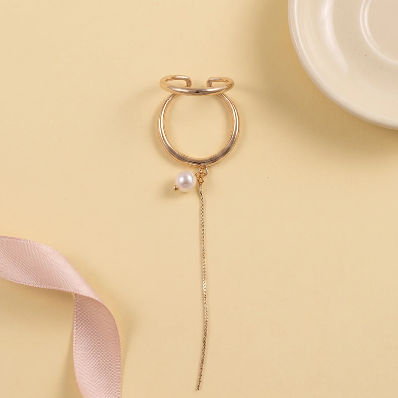 Flat lay of Gold Pearl Chain Ear Cuff
