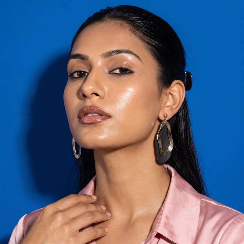 Model wearing Sculptural Undulating Open Hoop Earrings