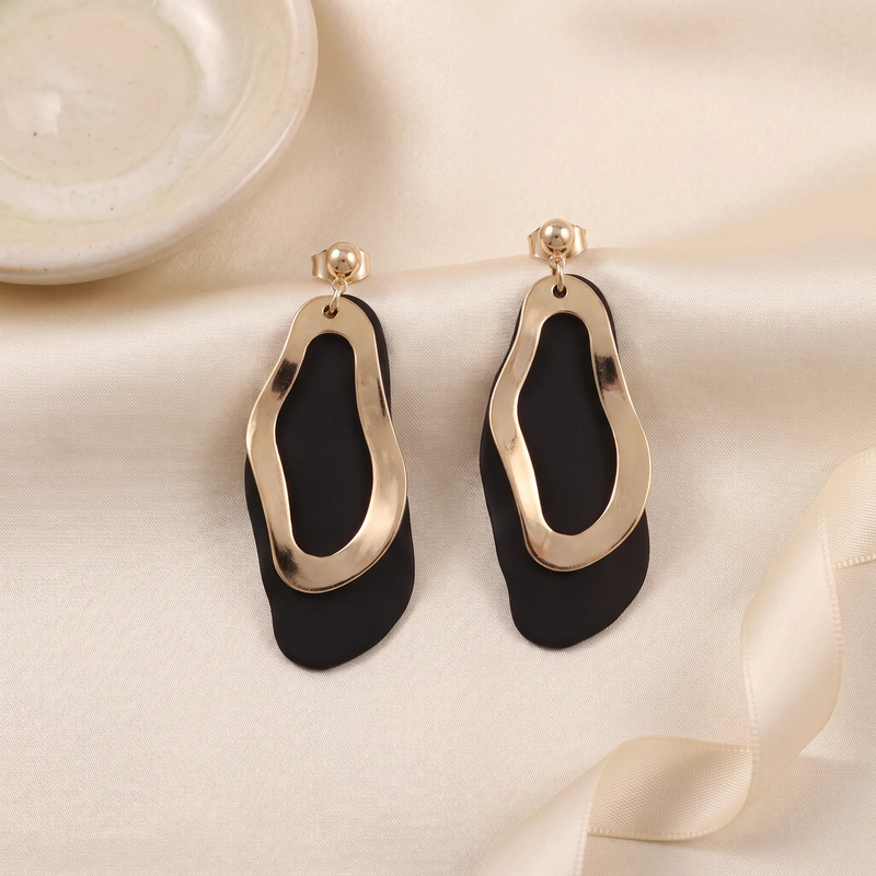 Flat lay of Sculptural Undulating Open Hoop Earrings