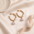 Flat lay of Twisted Gold Hoop Pearl Drop Earrings