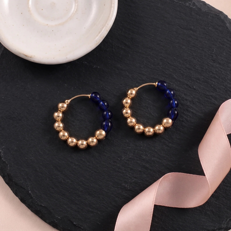 Flat lay of Sapphire Luxe Hoops