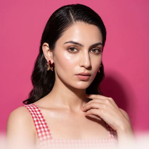 Model wearing Ruby Élan Star Earrings