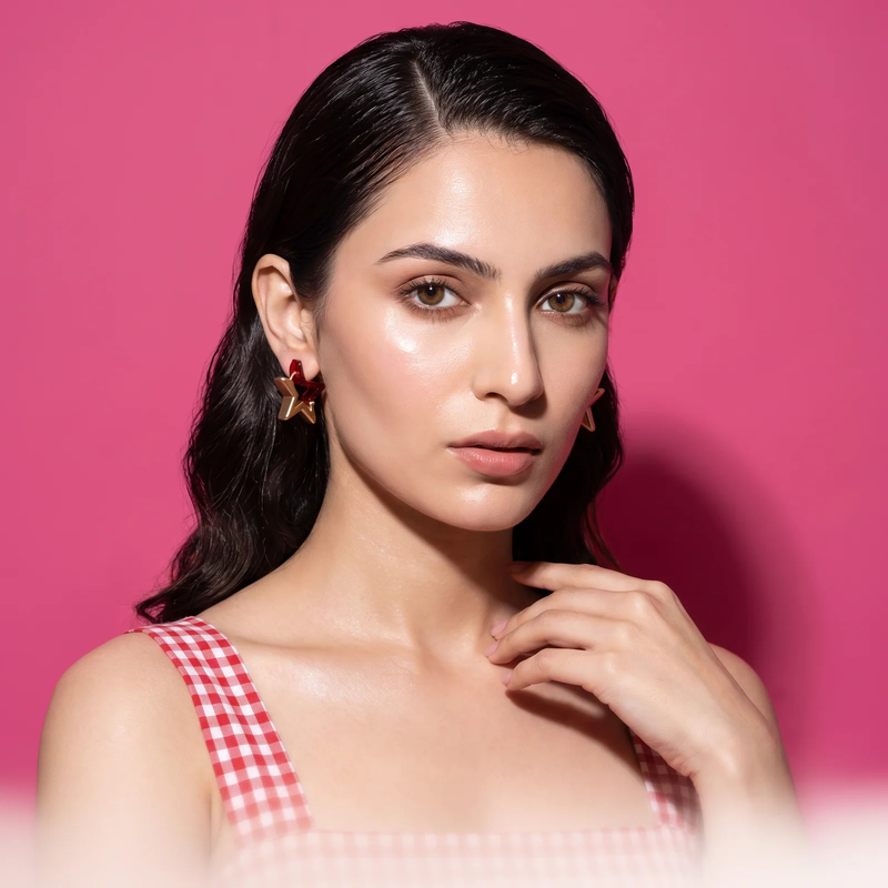Model wearing Ruby Élan Star Earrings