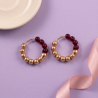 Flat lay of Ruby Luxe Beaded Hoops