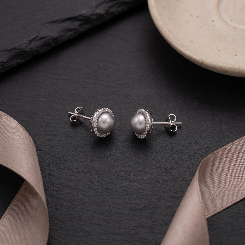 Flat lay of Grey Pearl Halo Studs