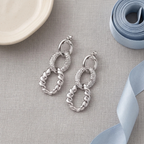 Flat lay of Mixed Texture Link Drop Earrings