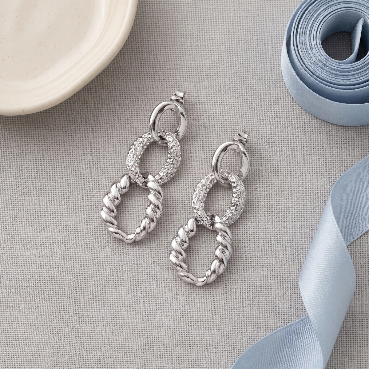 Flat lay of Mixed Texture Link Drop Earrings