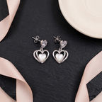 Flat lay of Double Heart Crystal Drop Earrings