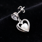 Close-up detail of Double Heart Crystal Drop Earrings