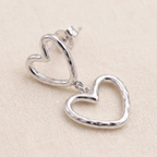 Close-up detail of Double Heart Outline Drop Earrings