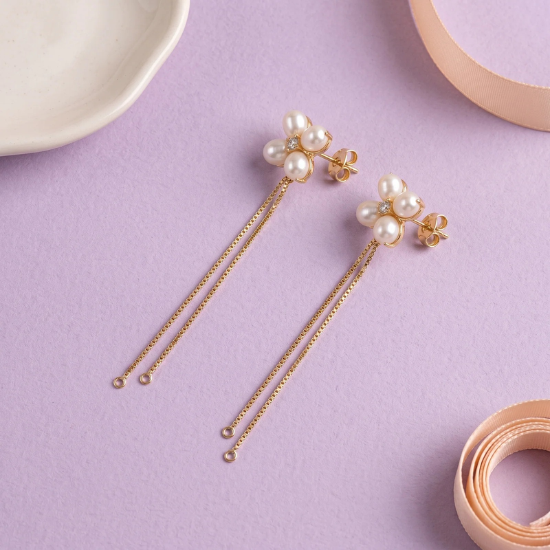 Flat lay of Pearl Clover Chain Drop Earrings