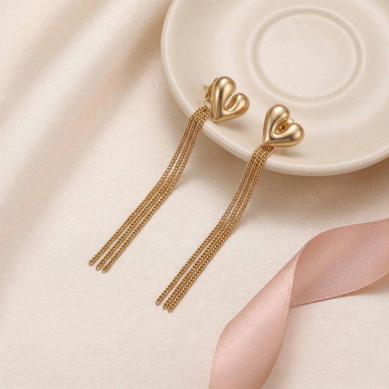 Flat lay of Sculptural Heart Fringe Earrings