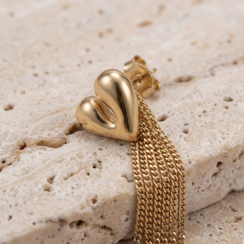 Close-up detail of Sculptural Heart Fringe Earrings