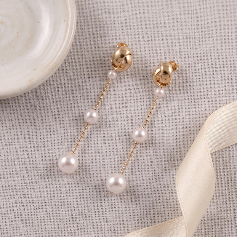 Flat lay of Graduated Pearl Chain Drop Earrings