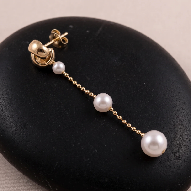 Close-up detail of Graduated Pearl Chain Drop Earrings