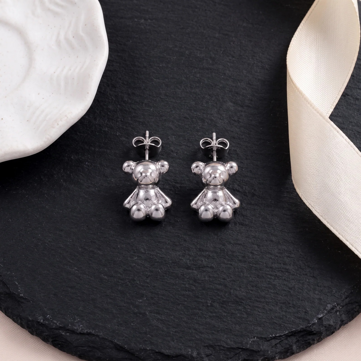 Flat lay of Teddy Bear Stud Earrings
