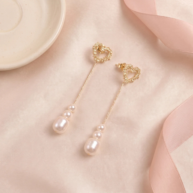 Flat lay of Crystal Heart Pearl Drop Earring