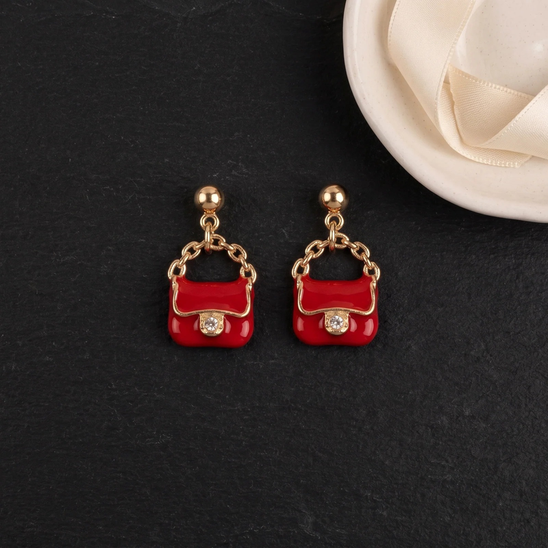Flat lay of Mini Handbag Charm Earrings
