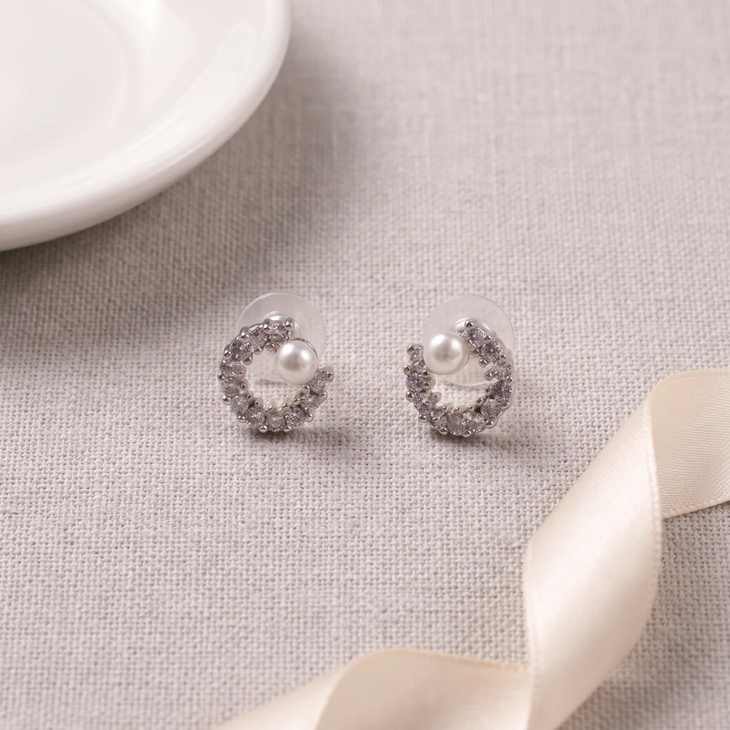 Flat lay of Crystal Crescent with Pearl Stud Earrings