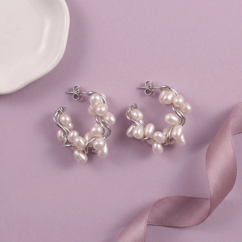 Flat lay of Pearl Cluster Wave Hoop Earrings