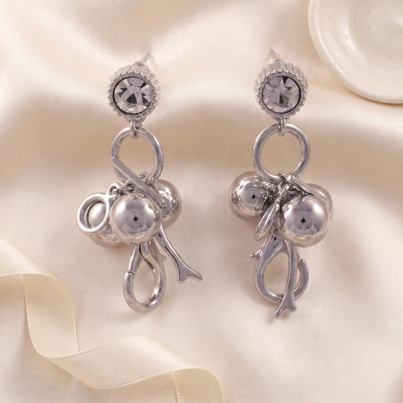 Flat lay of Crystal Cherry Branch Drop Earrings