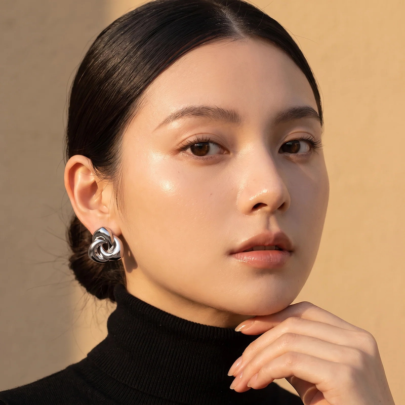 Model wearing Chunky Twisted Knot Stud Earrings