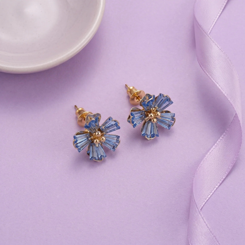 Flat lay of Sapphire Crystal Flower Stud Earrings
