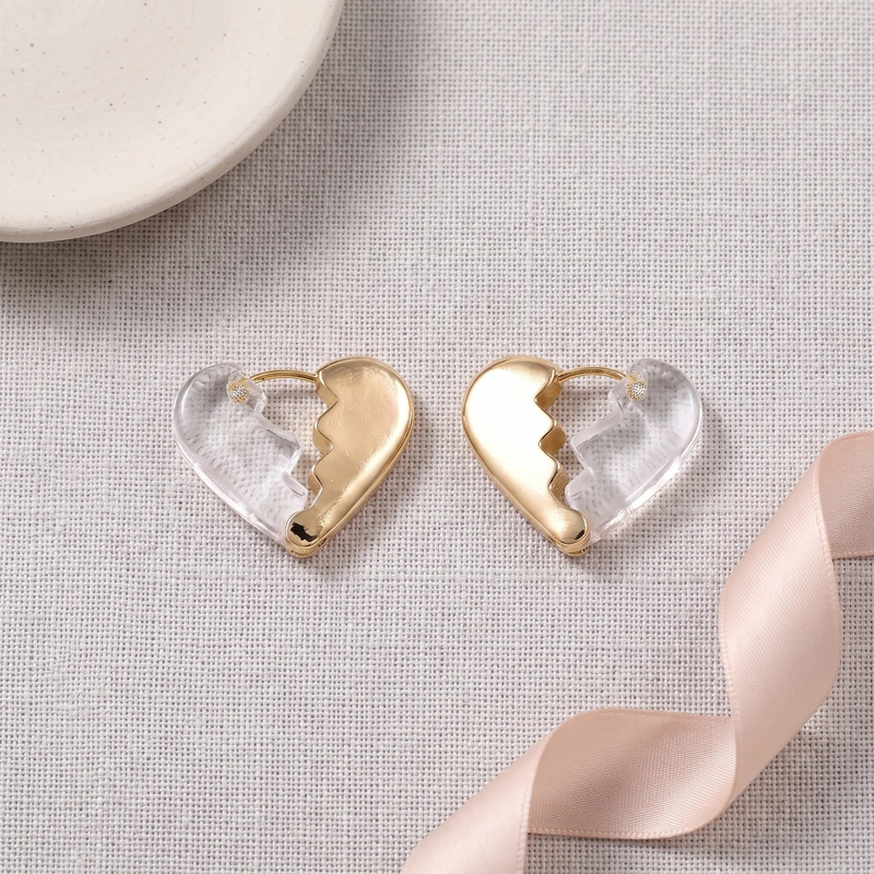 Flat lay of Clear Acrylic Broken Heart Hoop Earrings