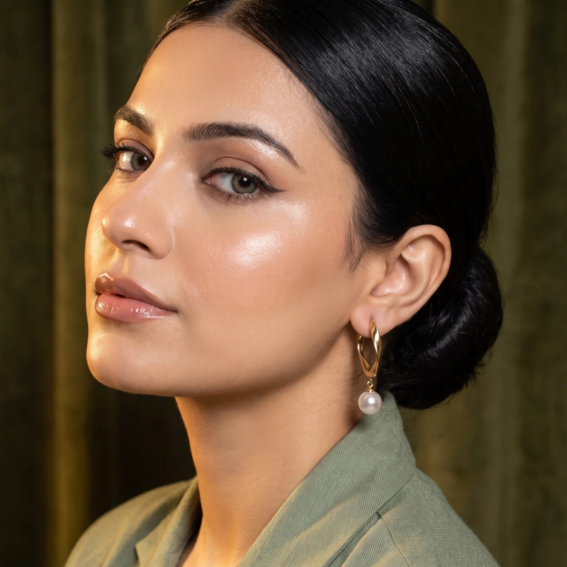Side profile on ear: Twisted Gold Hoop Pearl Drop Earrings