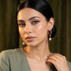 Model wearing Twisted Gold Hoop Pearl Drop Earrings