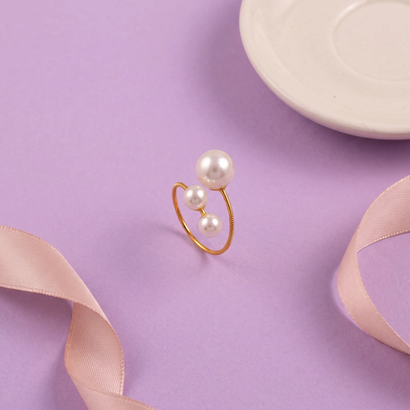 Flat lay of Triple Pearl Open Ring