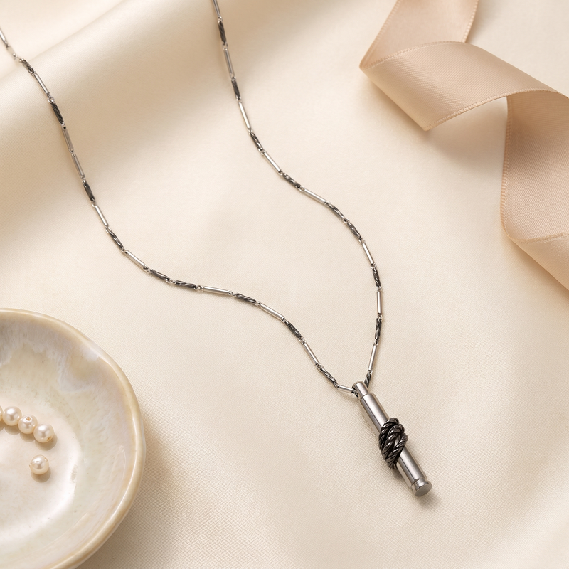 Flat lay of Twisted Bullet Pendant Necklace