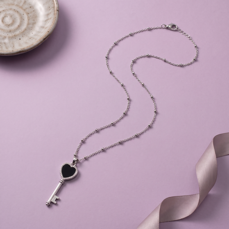 Flat lay of Black Heart Key Pendant Chain