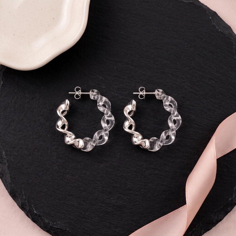 Flat lay of Silver and Twisted Resin Hoop Earrings