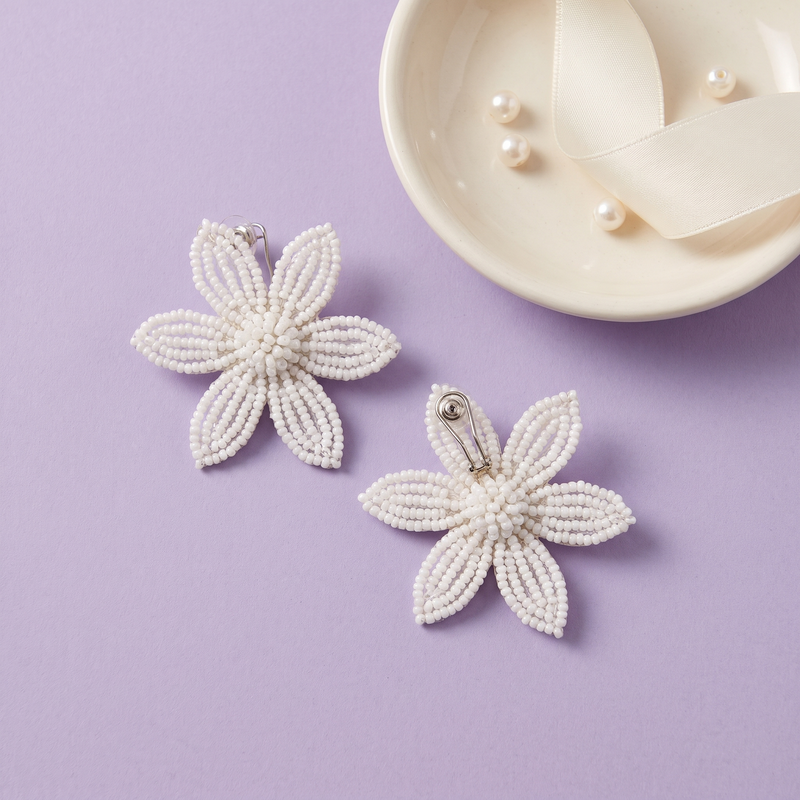 Flat lay of Pearl Bloom Floral Earrings